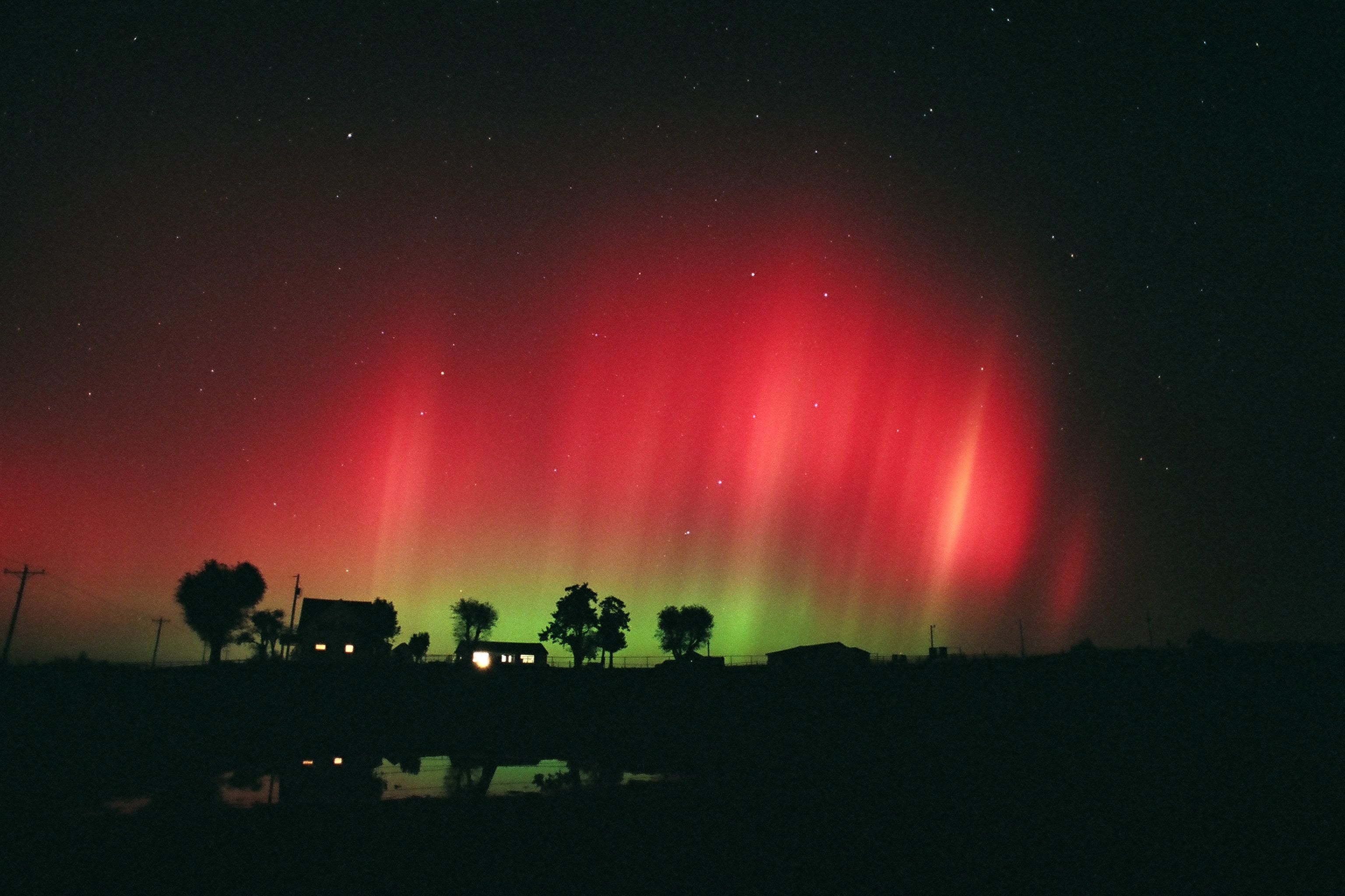 Photo of aurora over houses in Oklahoma.