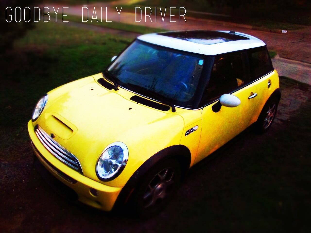 Color photo looking out over my handlbars out into a rainy parking lot.