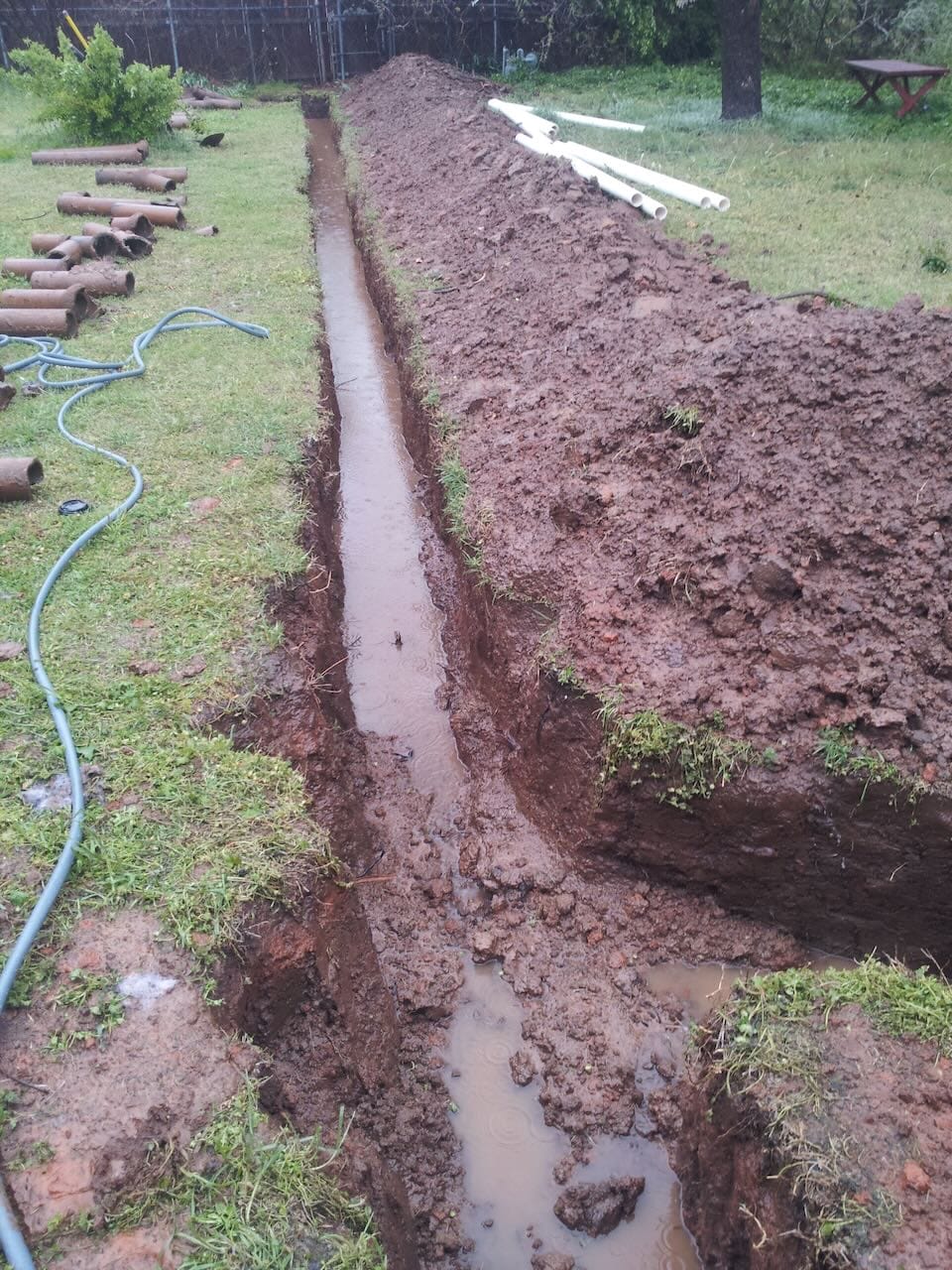 Color collage of Grace's old sewer line trench filled with water.