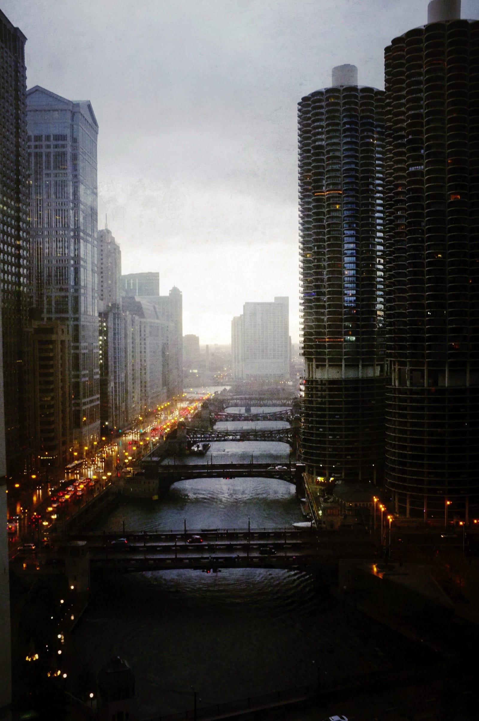 Color photo looking west up the Chicago River at dusk.