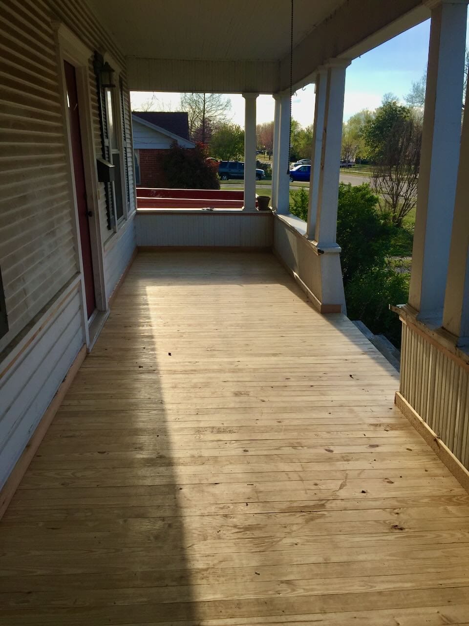Color photo our porch after laying down new decking.