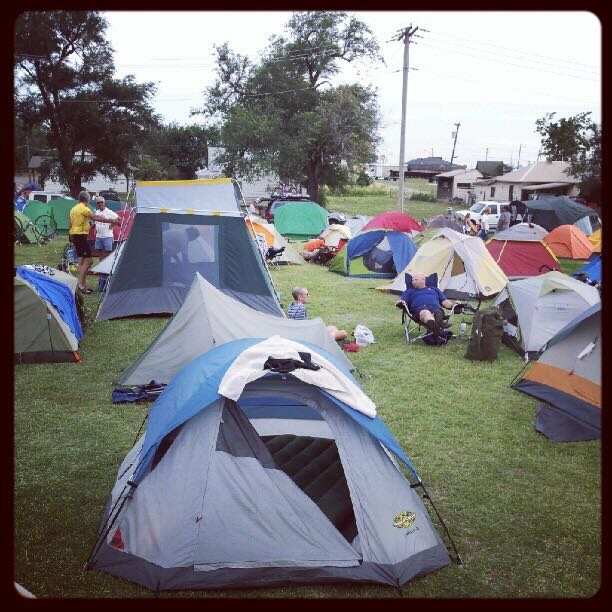 Color photo of field filled with tents.