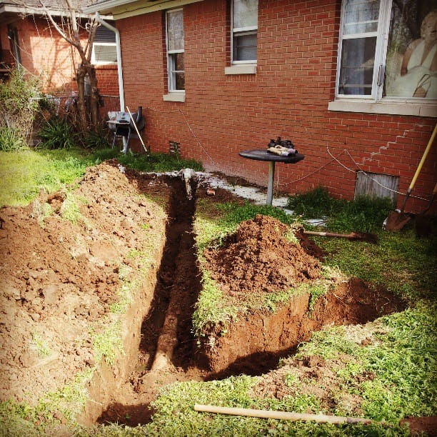 Color photo of Grace's sewer line being slowly dug up.