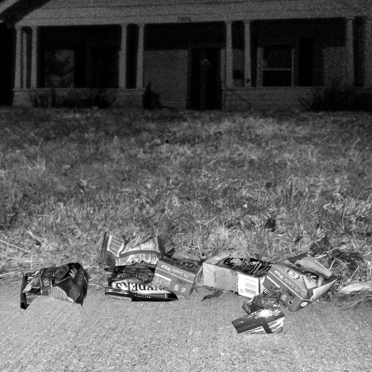 B&W photo of food on the sidewalk in front of our house.