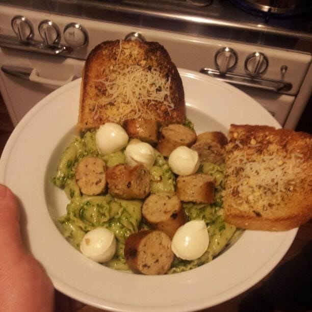 Color photo of pesto pasta and chicken sausage.