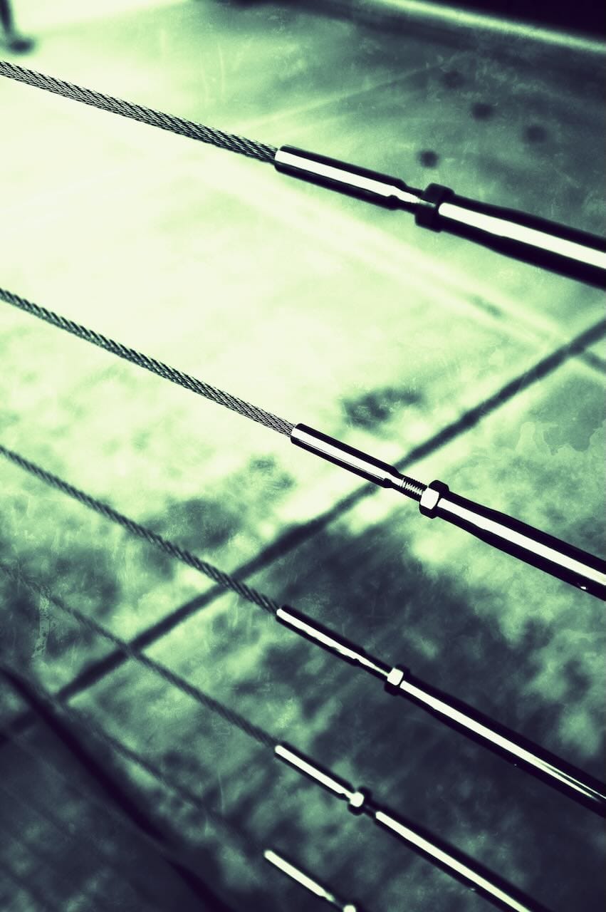 Green tinted photo of cables on a balcony.