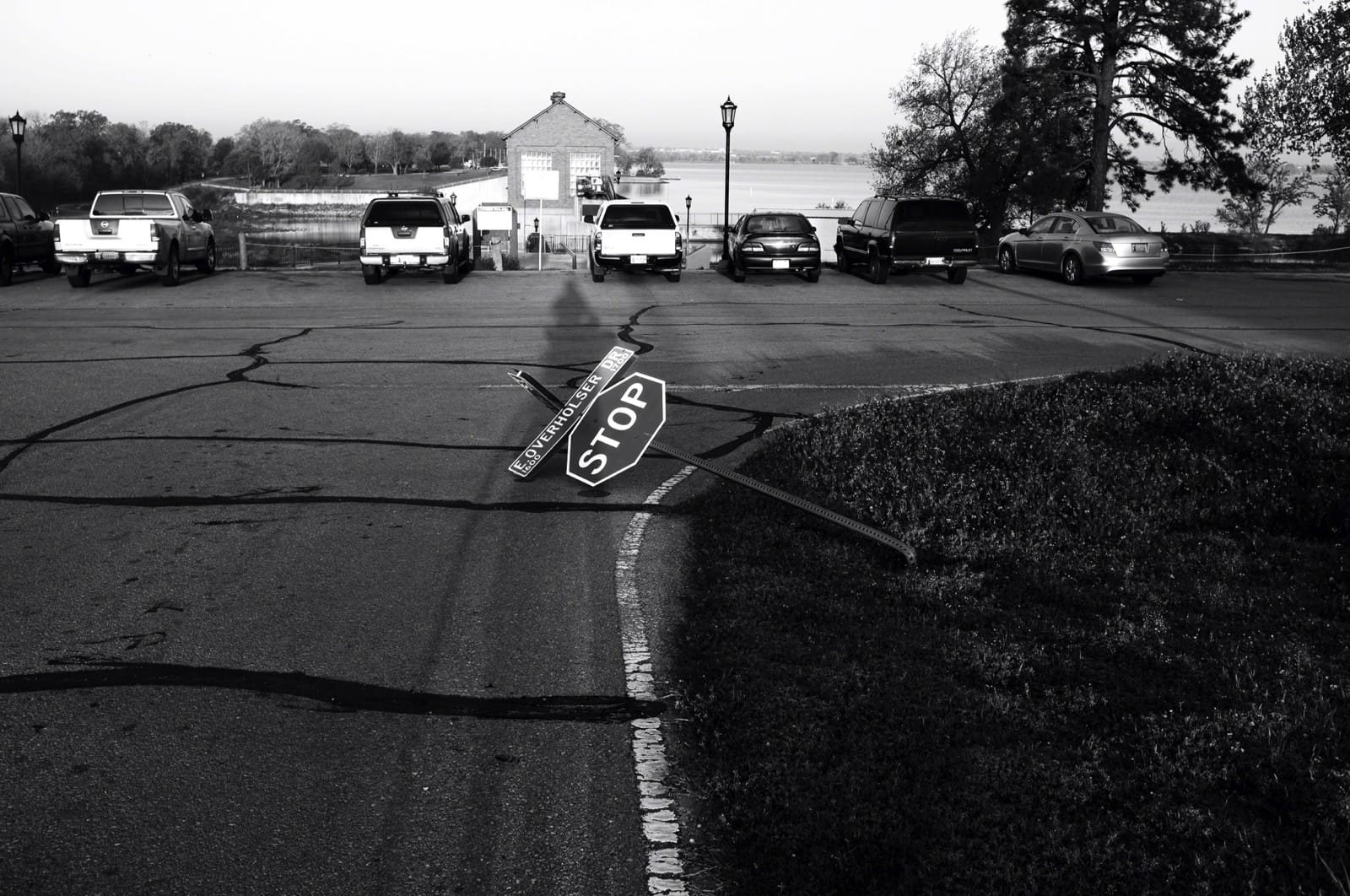 B&W photo of a stop sign knocked over.