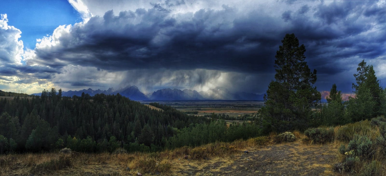 Color photo of rain falling on the Grand Tetons.